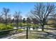 Scenic neighborhood view from balcony overlooking lush greenery, tranquil pond and mature trees at 5390 Rosemary Ln, Denver, CO 80221