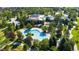 Stunning aerial view of the community pool and clubhouse surrounded by lush landscaping and mature trees at 8627 Gold Peak Pl # C, Highlands Ranch, CO 80130