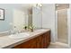 Spacious bathroom features double sinks, modern fixtures, sleek countertops, and a separate glass-enclosed shower at 8627 Gold Peak Pl # C, Highlands Ranch, CO 80130