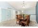 Comfortable dining room with a dark wooden table, six chairs, neutral carpet, and light blue walls at 8627 Gold Peak Pl # C, Highlands Ranch, CO 80130