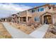 Attractive multi-story home with a stone facade and tidy landscaping with walkway leading to an arched entrance at 8627 Gold Peak Pl # C, Highlands Ranch, CO 80130