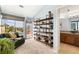Relaxing living room with a modern bookshelf, a green couch, and a view of the outside patio at 8627 Gold Peak Pl # C, Highlands Ranch, CO 80130