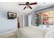 Bright bedroom with a patio door to the outside, ceiling fan, and an ensuite bathroom and walk in closet at 8627 Gold Peak Pl # C, Highlands Ranch, CO 80130
