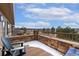 Spacious patio with stone detailing and a serene view of the neighborhood and distant landscapes, ideal for relaxation at 8627 Gold Peak Pl # C, Highlands Ranch, CO 80130