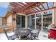Charming backyard patio with a pergola, complete with wrought iron seating for relaxed outdoor living and entertainment at 8627 Gold Peak Pl # C, Highlands Ranch, CO 80130