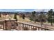 Scenic neighborhood view from a stone-railed patio featuring lush greenery and distant landscapes, perfect for enjoying the outdoors at 8627 Gold Peak Pl # C, Highlands Ranch, CO 80130