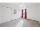 Bright bedroom with plush carpeting, large window, and ample closet space at 1629 S Deframe St # A1, Lakewood, CO 80228