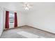 Bright bedroom with large window and plush carpeting at 1629 S Deframe St # A1, Lakewood, CO 80228