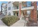 Exterior view of a multi-story building with brick accents, balconies, and well-maintained landscaping at 1629 S Deframe St # A1, Lakewood, CO 80228
