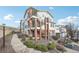 Wide angle exterior view of a multi-story building with staircase and balconies, surrounded by lush landscaping at 1629 S Deframe St # A1, Lakewood, CO 80228