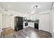 Well-lit kitchen featuring black appliances, sleek countertops and tile backsplash at 1629 S Deframe St # A1, Lakewood, CO 80228