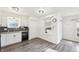 Bright kitchen features wood-look floors, white cabinets, and stainless steel appliances at 1629 S Deframe St # A1, Lakewood, CO 80228