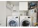 Well-lit laundry room with washer, dryer, and utility sink at 1629 S Deframe St # A1, Lakewood, CO 80228