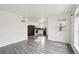 Bright living room with modern flooring that flows into the kitchen with black appliances at 1629 S Deframe St # A1, Lakewood, CO 80228