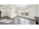 Living room with wood-look flooring, large arched window, and natural light at 1629 S Deframe St # A1, Lakewood, CO 80228