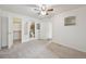Spacious main bedroom with plush carpeting, ceiling fan, walk-in closet and en-suite bathroom at 1629 S Deframe St # A1, Lakewood, CO 80228