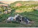 High angle view showcasing the architectural design of this beautiful home and valley views at 12947 Lazy Dog Ln, Littleton, CO 80127