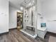 Modern bathroom featuring a spacious glass shower with marble tiling and a built-in bench at 12947 Lazy Dog Ln, Littleton, CO 80127
