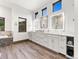 Bright bathroom featuring dual sinks, modern fixtures, and tile flooring at 12947 Lazy Dog Ln, Littleton, CO 80127
