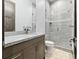 Modern bathroom with granite countertops, walk-in shower, and tiled shower walls at 12947 Lazy Dog Ln, Littleton, CO 80127