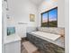 Luxurious bathtub with stylish tile surround and natural light at 12947 Lazy Dog Ln, Littleton, CO 80127