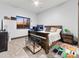 Well-lit bedroom includes a window with sunset views, a desk, and carpeted floors at 12947 Lazy Dog Ln, Littleton, CO 80127
