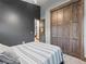 Another view of the comfortable bedroom featuring a dark accent wall and spacious closet at 12947 Lazy Dog Ln, Littleton, CO 80127