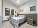 Cozy bedroom with neutral walls, a comfortable bed, and natural light streaming through the windows at 12947 Lazy Dog Ln, Littleton, CO 80127