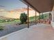 Covered patio with wooden support columns overlooks the beautiful landscape and mountain views at 12947 Lazy Dog Ln, Littleton, CO 80127