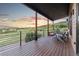 Inviting deck features wood floors, steel railings, and comfortable seating with spectacular views at 12947 Lazy Dog Ln, Littleton, CO 80127