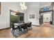 Modern dining room with hard wood flooring, black leather chairs, and chandelier at 12947 Lazy Dog Ln, Littleton, CO 80127