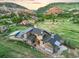 A high angle showcases the home's unique architectural design and surrounding mountain landscape at 12947 Lazy Dog Ln, Littleton, CO 80127