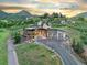 Beautiful exterior of a home at sunset with a two-car garage and lush landscaping at 12947 Lazy Dog Ln, Littleton, CO 80127