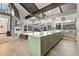 Gourmet kitchen featuring a large island, vaulted ceilings, and stainless steel appliances at 12947 Lazy Dog Ln, Littleton, CO 80127