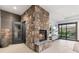 Cozy living room featuring a stone fireplace and hearth next to an adjacent door at 12947 Lazy Dog Ln, Littleton, CO 80127