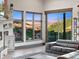 Sunlit living room featuring large windows with stunning mountain views and modern shelving at 12947 Lazy Dog Ln, Littleton, CO 80127