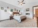Comfortable main bedroom featuring a fireplace, ceiling fan, and neutral color palette at 12947 Lazy Dog Ln, Littleton, CO 80127