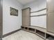 Well-organized mudroom with built-in storage, seating, and multiple hooks for hanging coats and bags at 12947 Lazy Dog Ln, Littleton, CO 80127