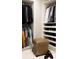 Organized walk-in closet with custom shelving for shoes and hanging space for clothes at 1133 14Th St # 3430, Denver, CO 80202