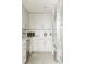 Well-organized kitchen features white cabinets, countertops, appliances, and stylish herringbone-patterned flooring at 1133 14Th St # 3430, Denver, CO 80202