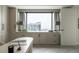 Home office with built in cabinets, large window with city views, and stylish desk at 1133 14Th St # 3430, Denver, CO 80202