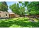 Spacious backyard with a fire pit and well-maintained lawn, ideal for outdoor activities at 2680 S Garfield Cir, Denver, CO 80210