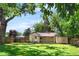 Green backyard featuring a storage shed and patio, perfect for outdoor enjoyment at 2680 S Garfield Cir, Denver, CO 80210