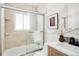Bright bathroom with tiled shower-tub, modern vanity, and stylish décor for a serene and updated space at 2680 S Garfield Cir, Denver, CO 80210