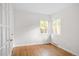 Bright bedroom with hardwood floors, fresh white paint, and double windows letting in an abundance of natural light at 2680 S Garfield Cir, Denver, CO 80210
