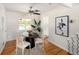 Bright dining room featuring hardwood floors, contemporary furniture, and ample natural light at 2680 S Garfield Cir, Denver, CO 80210