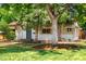 Charming home exterior surrounded by lush greenery and a beautiful lawn at 2680 S Garfield Cir, Denver, CO 80210