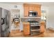 Well-equipped kitchen with stainless steel appliances and oak cabinets at 2680 S Garfield Cir, Denver, CO 80210