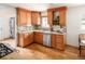 Well-lit kitchen featuring wood cabinets, stainless steel appliances, and marble countertops at 2680 S Garfield Cir, Denver, CO 80210