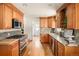 Spacious updated kitchen featuring hardwood floors, custom cabinetry and gas range at 2680 S Garfield Cir, Denver, CO 80210